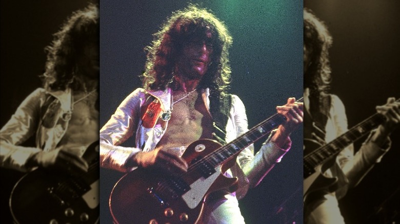 Jimmy Page playing guitar in 1975