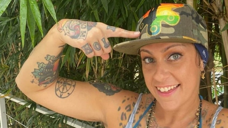 Danielle Colby pointing to hat