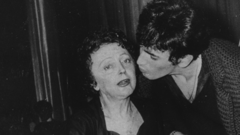  Edith Piaf being kissed on the cheek 