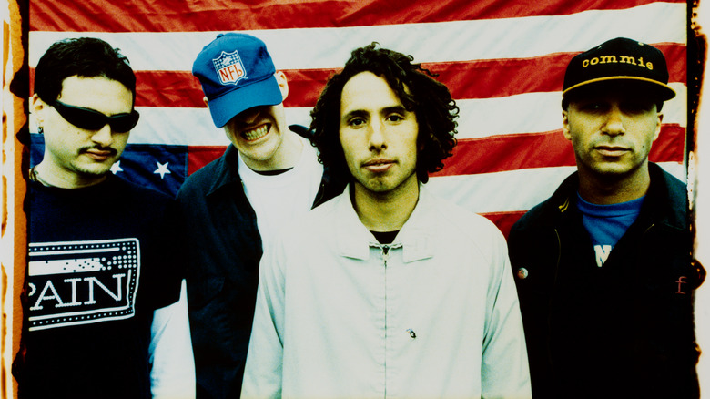 RATM posing against upside-down flag