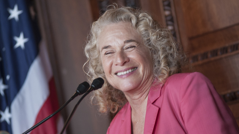 Carole King at a podium in 2013