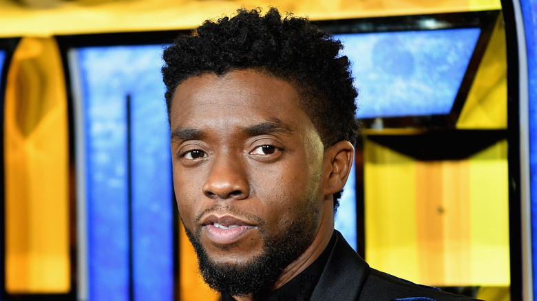 Chadwick Boseman in front of a movie poster