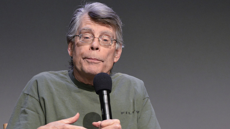 Stephen King holding microphone