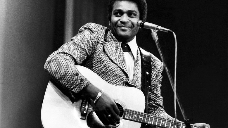 Charley Pride playing guitar