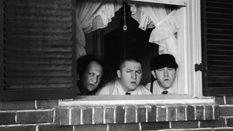 The classic Three Stooges lineup looking out window
