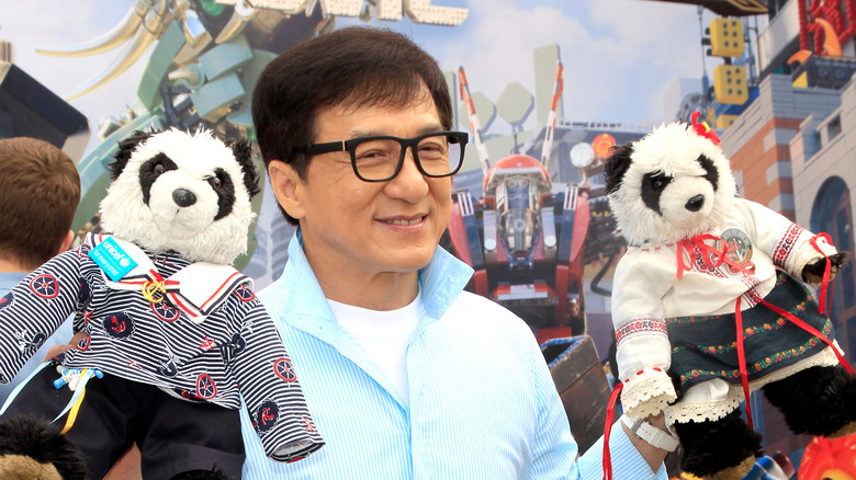 Jackie Chan holding his panda bears