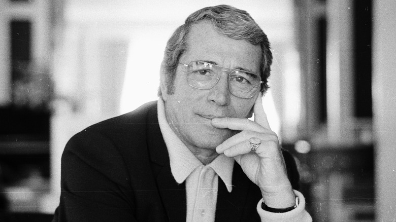 Perry Como with hand on chin, wearing glasses