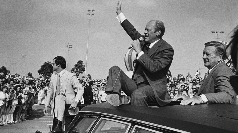 John Wayne with John Ford at a parade 