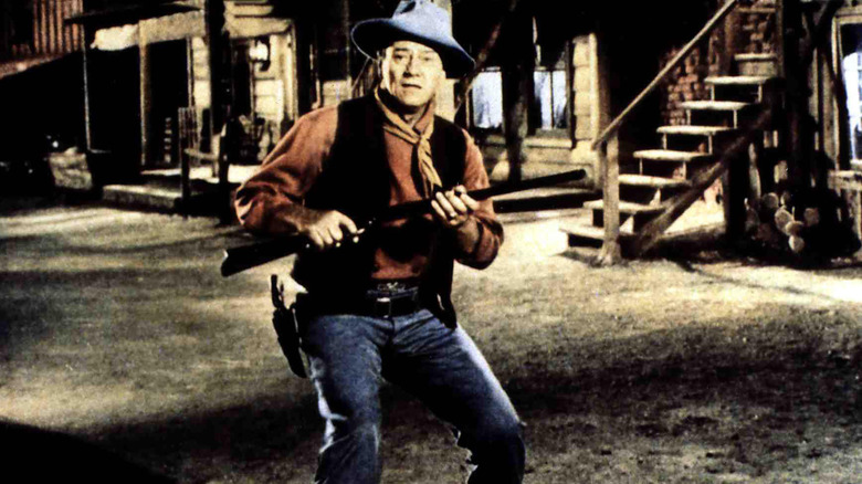 John Wayne holding his gun surprised in Rio Bravo 