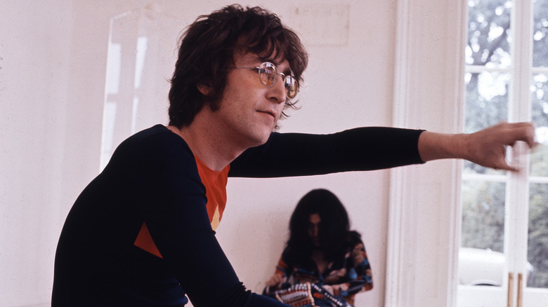 John Lennon hand on door Yoko Ono background