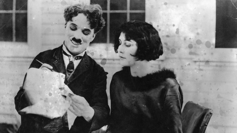Charlie Chaplin with wife, smiling 
