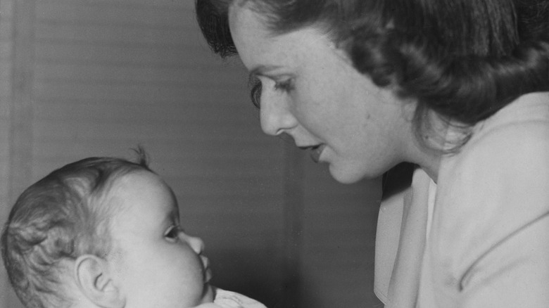 Joan Barry looking at baby
