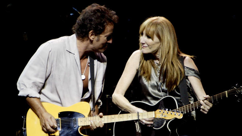 Springsteen and Scialfa playing guitars
