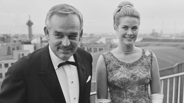 Prince Rainier III and Grace Kelly, posing and smiling outside