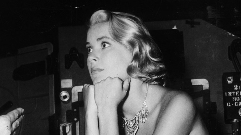 Grace Kelly seated, resting hands on chin