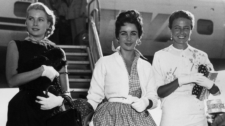 Grace Kelly, Liz Taylor, Lorraine Day all walking off airplane