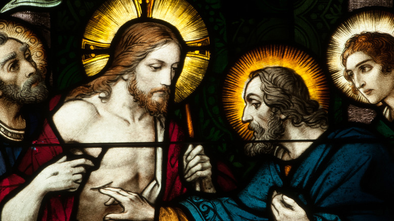 A stained glass window featuring Jesus and St. Thomas