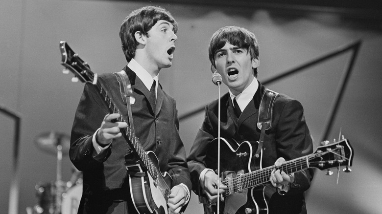Young Paul McCartney and George Harrison performing