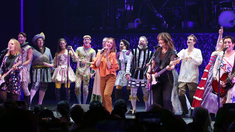 The Go-Go's on stage with cast of 
