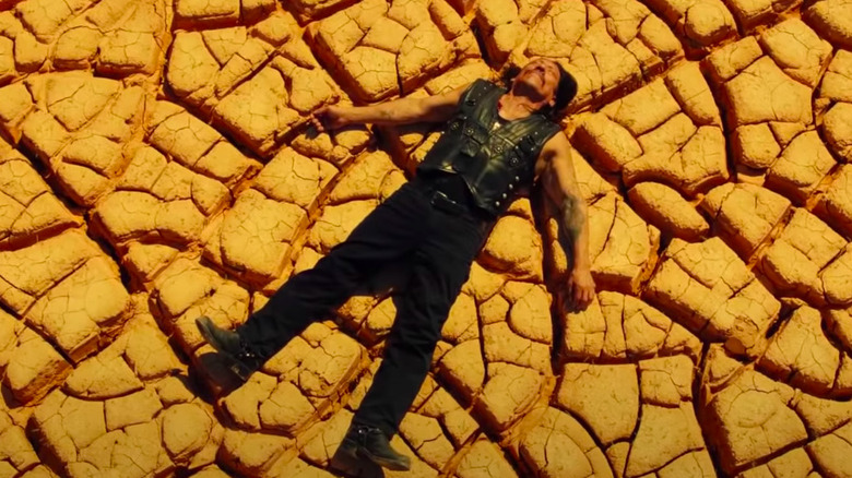 Danny Trejo laying on the ground in Machete