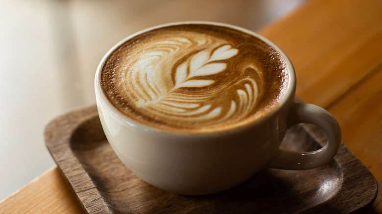 coffee cup on brown wood coaster