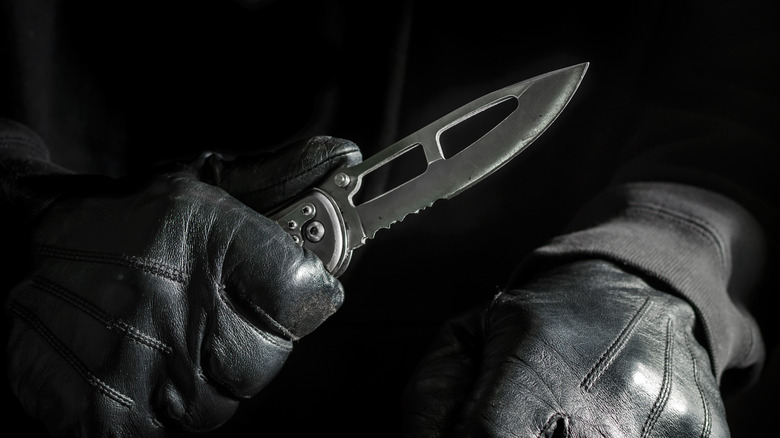 A knife in a gloved hand