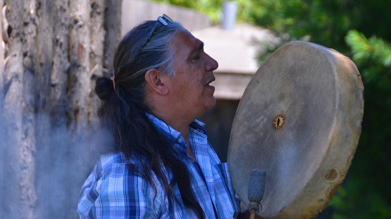 Native man playing drum 