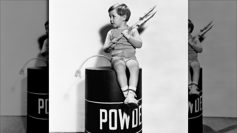 little boy playing with fireworks