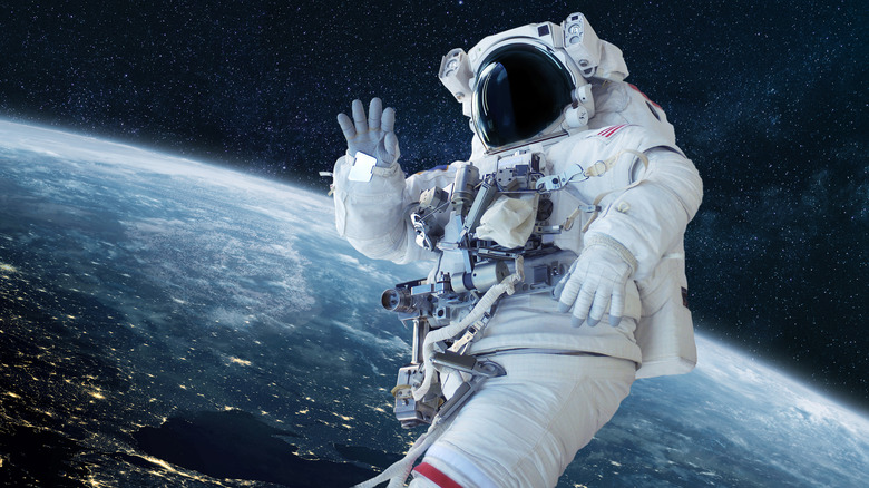 Astronaut in space waving