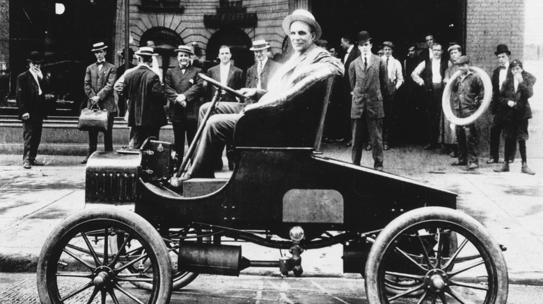 Henry Ford sits in car
