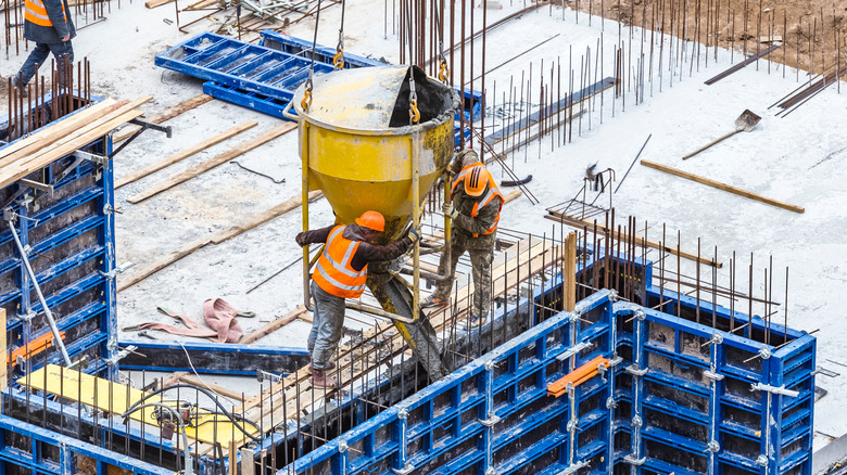 Workers using concrete hopper