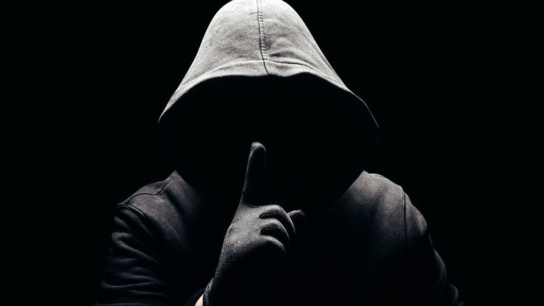 Hooded man in the dark