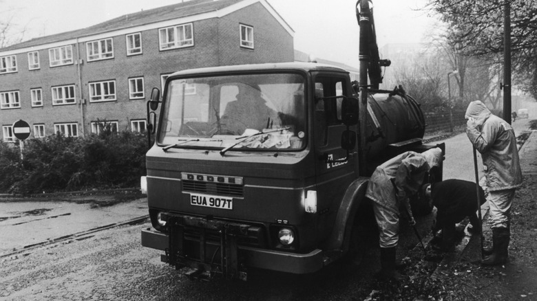 In their search for evidence, police clear the drains outside the Leeds home of murder victim Jacqueline Hill, 26th November 1980. A 20-year-old student, she was the 13th, and last, victim of serial killer Peter Sutcliffe