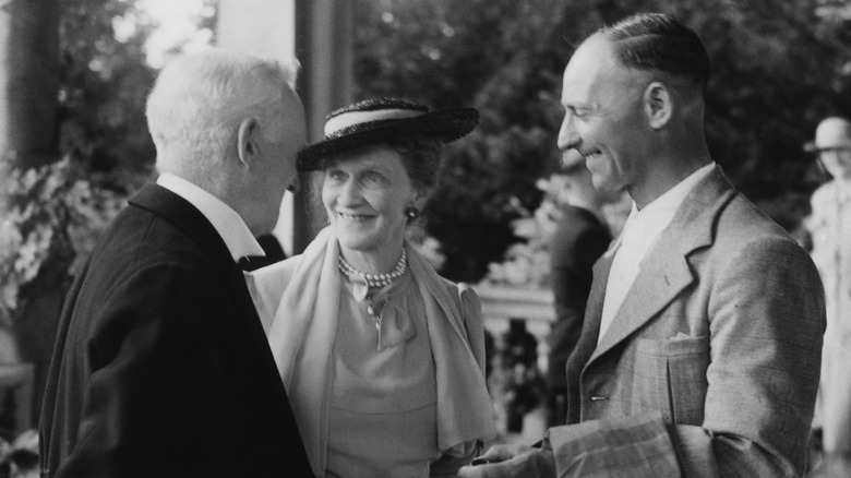 Nancy Astor talking to two men at her retirement party