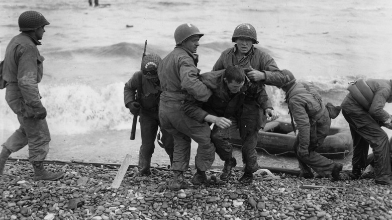Soldiers dealing with wounded on D-Day