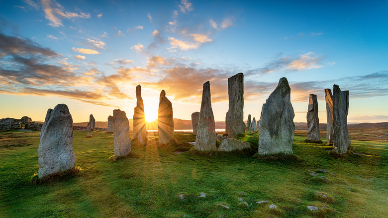Sun rising behind Scotland's Callanish Stones.