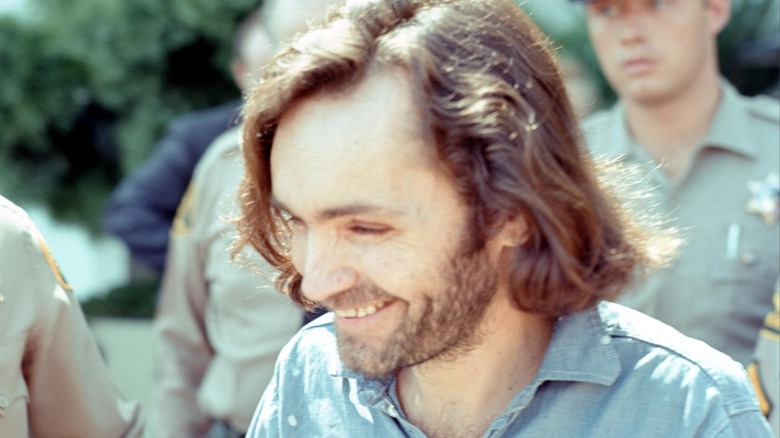 Charles Manson smiling with sherriff