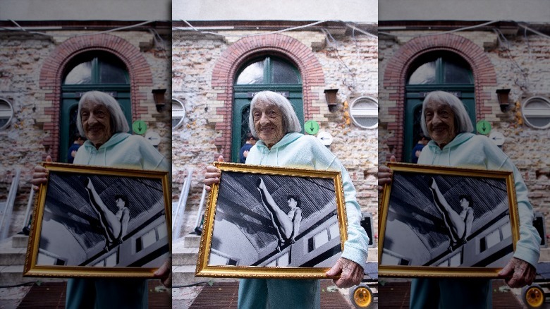Agnes Keleti holding a picture of herself