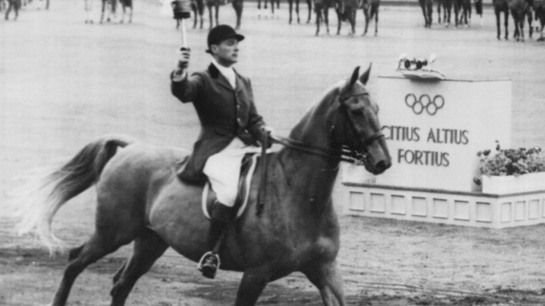 Equestrian carrying torch at Stockholm set of 1956 Olympics