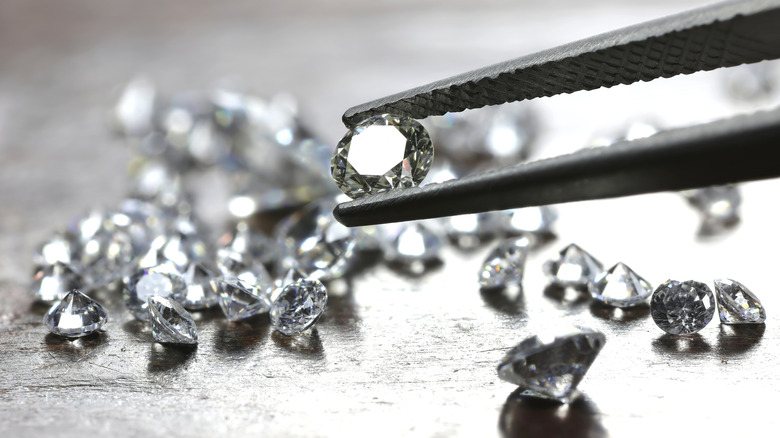 Tweezers picking up diamond