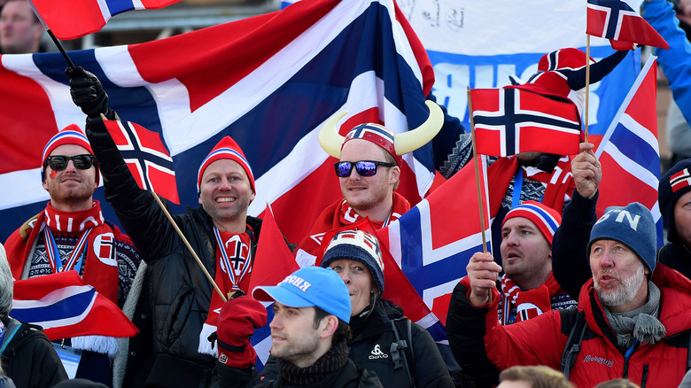 Norwegian fans waving flags during 2014 Winter Olympics