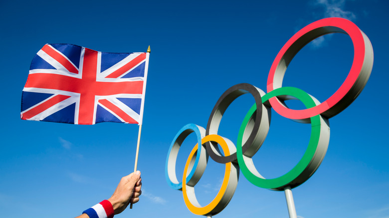 British flag held next to Olympic rings