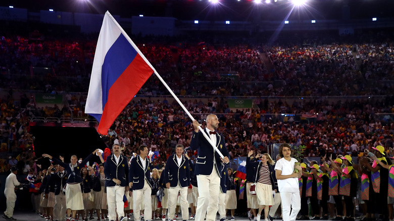 Man carrying Russian flag at Olympic ceremony 