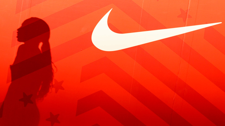 Allyson Felix beside Nike logo