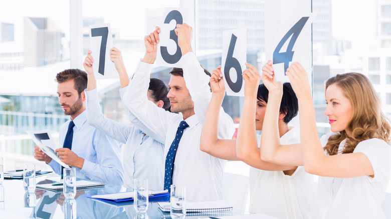 Judges holding up score cards