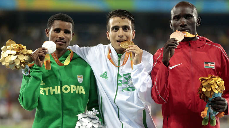 Silver medalist Tamiru Demisse of Ethiopia, gold medalist Abdellatif Baka of Algeria and bronze medalist Henry Kirwa