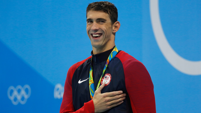 Michael Phelps poses with medal