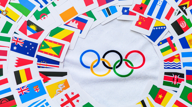 World flags surrounding Olympic rings