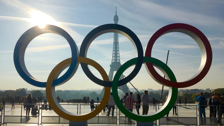 Olympic rings stand in front of Eiffel Tower