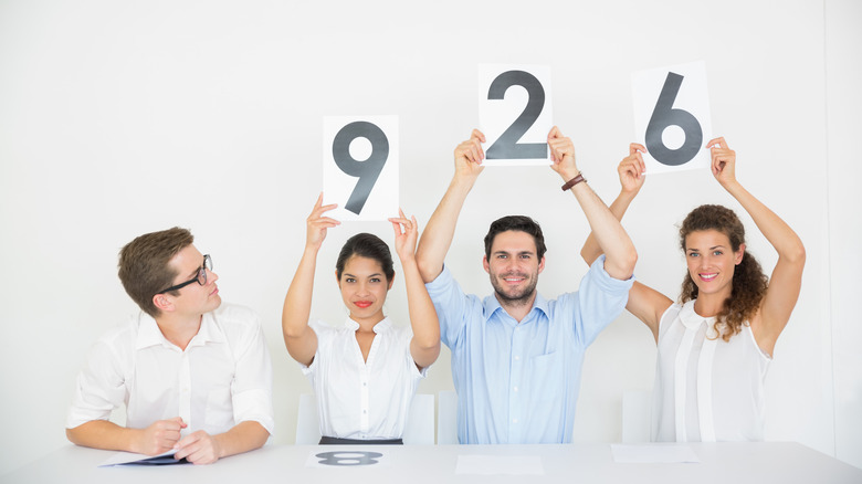 Judges hold up score cards